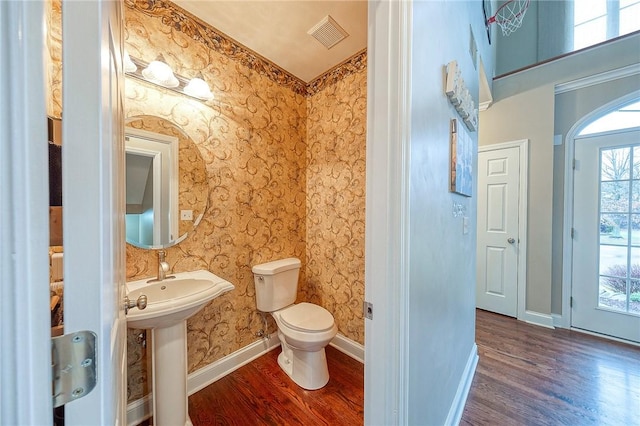 bathroom with hardwood / wood-style floors and toilet