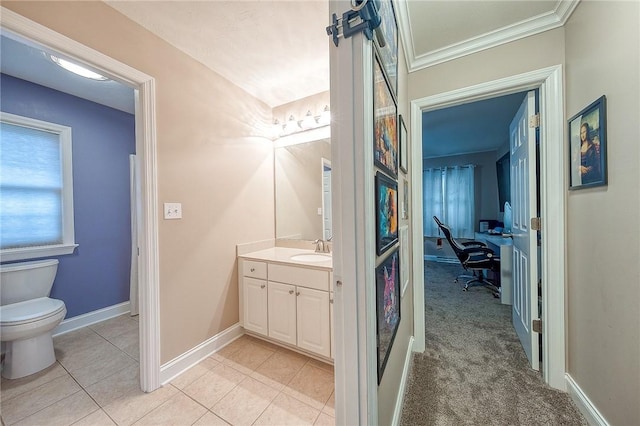 bathroom featuring vanity, tile patterned flooring, ornamental molding, and toilet