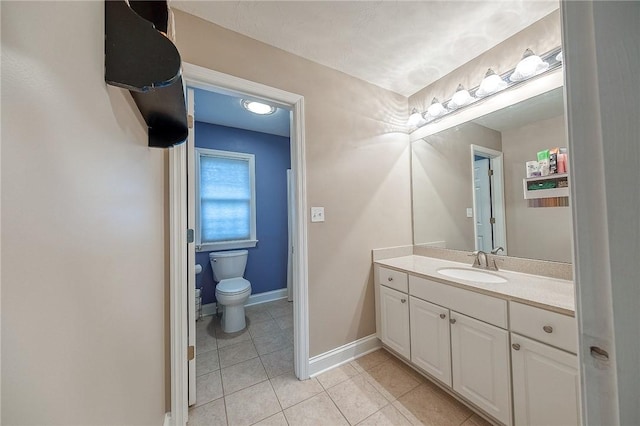 bathroom featuring vanity, tile patterned floors, and toilet