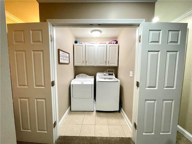 laundry area featuring cabinets, light tile patterned floors, and independent washer and dryer