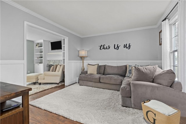 living room featuring ornamental molding, hardwood / wood-style floors, and built in features