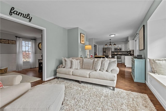 living room with crown molding and dark hardwood / wood-style floors