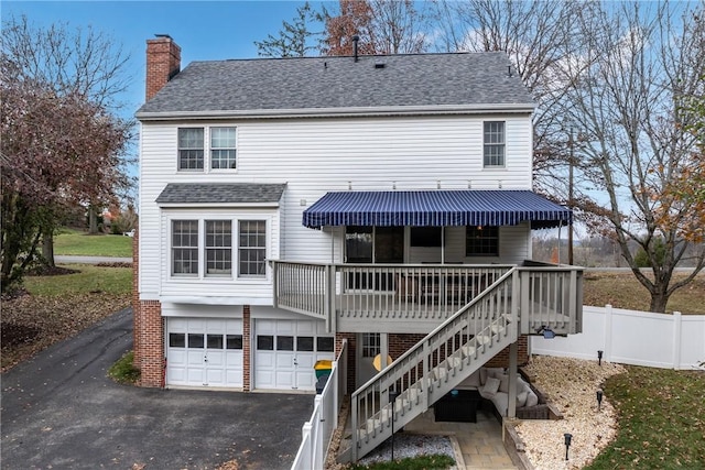 back of property with a garage