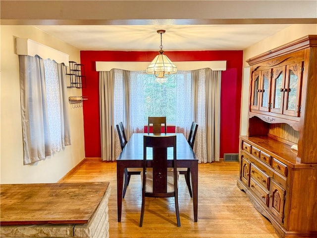 dining space with an inviting chandelier and light wood-type flooring