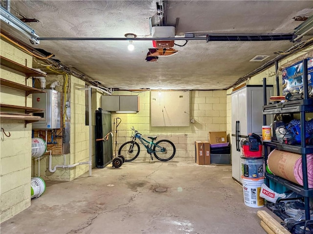 garage featuring a garage door opener and water heater