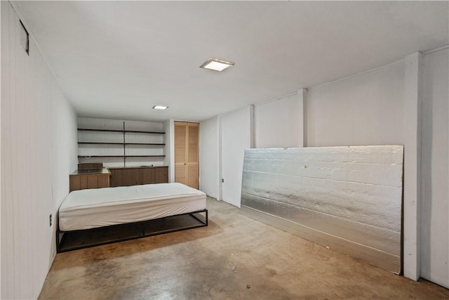 bedroom featuring concrete flooring