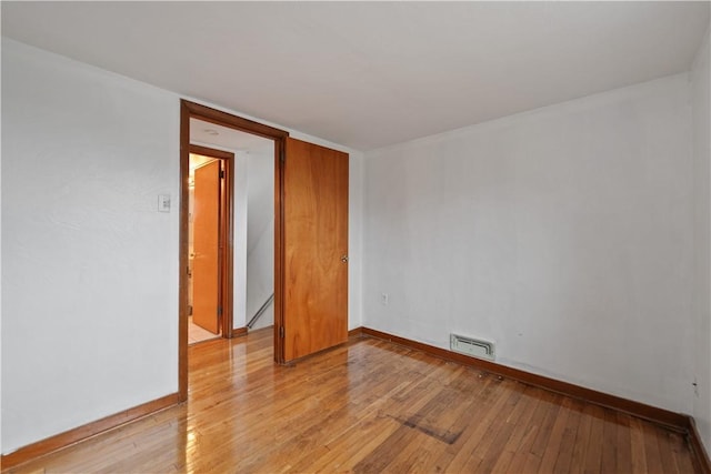 spare room featuring light hardwood / wood-style flooring