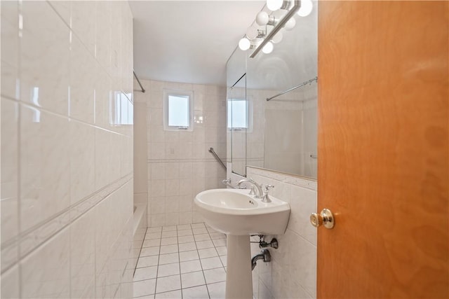 bathroom featuring tile patterned flooring, sink, tile walls, and shower / bathing tub combination