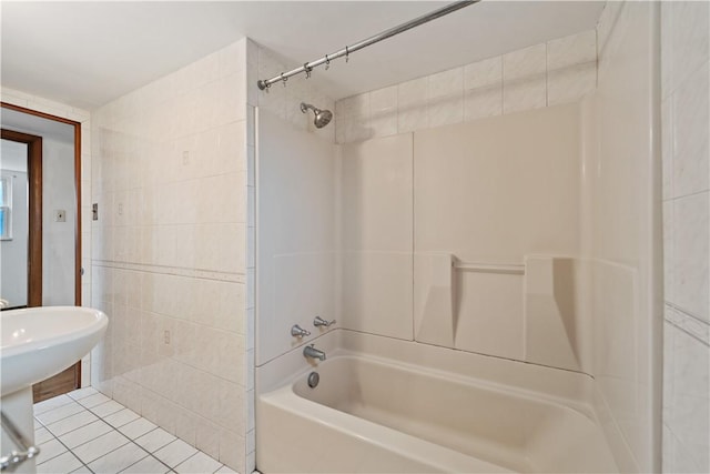 bathroom featuring tub / shower combination, tile patterned flooring, and tile walls