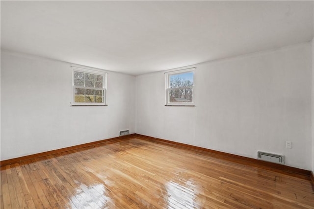 spare room with hardwood / wood-style floors