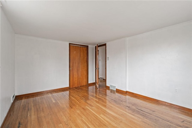 spare room featuring light hardwood / wood-style floors