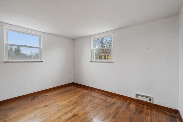 empty room featuring wood-type flooring and a wealth of natural light