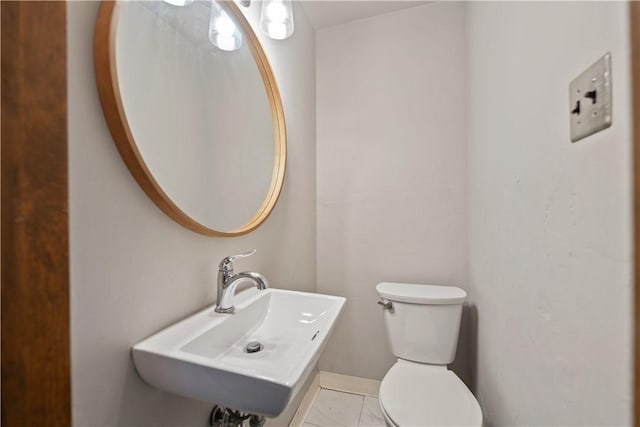 bathroom featuring tile patterned floors, toilet, and sink