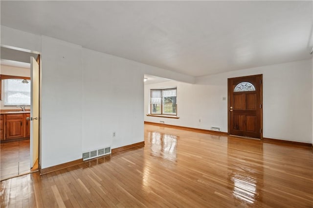 interior space with sink and light hardwood / wood-style floors