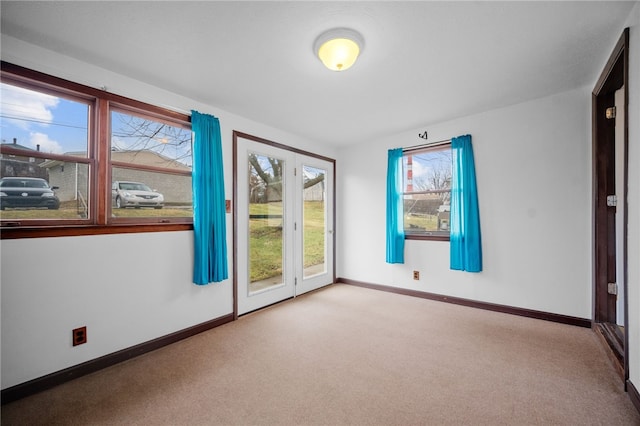 spare room featuring light colored carpet