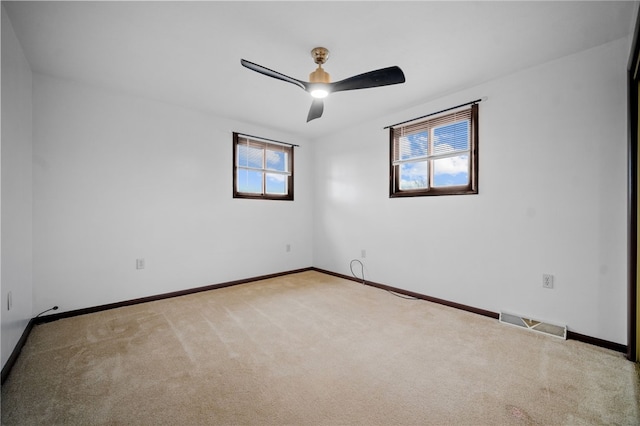 carpeted empty room featuring ceiling fan