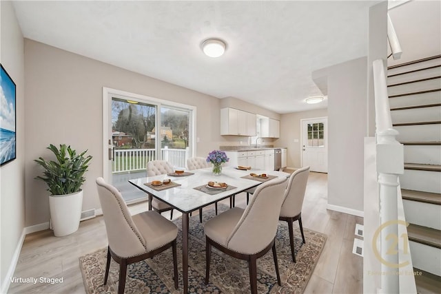 dining area featuring sink and light wood-type flooring