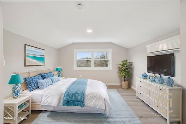 bedroom featuring vaulted ceiling and light hardwood / wood-style floors