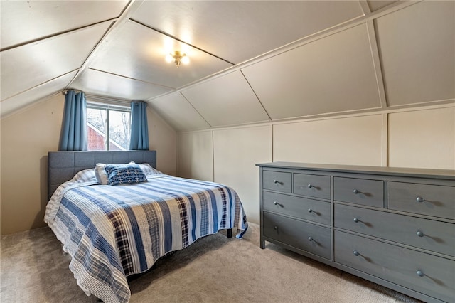 bedroom with vaulted ceiling and light carpet