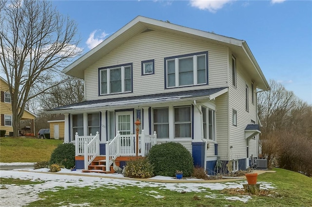 view of front of home with central AC unit and a front yard