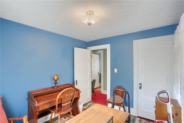 office area with a textured ceiling