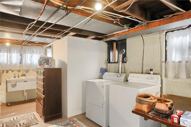 laundry area with separate washer and dryer and sink