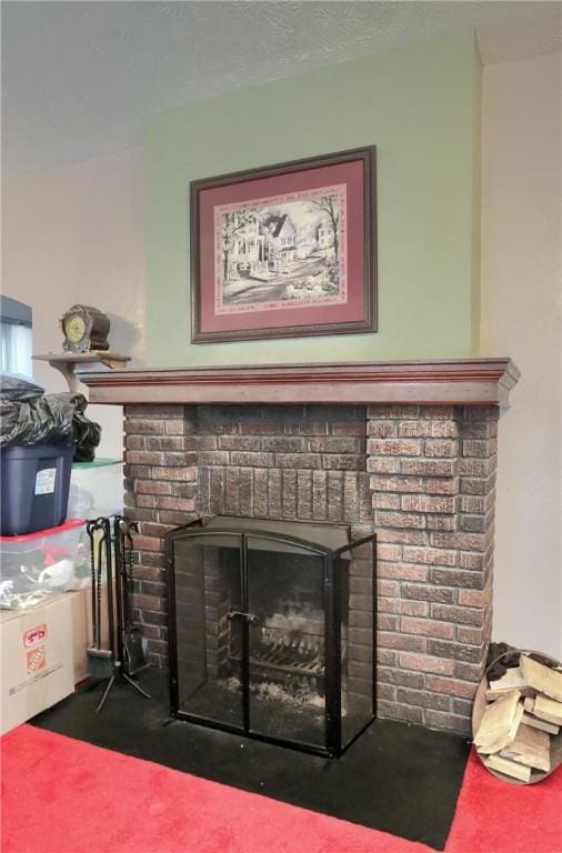 room details featuring a brick fireplace and carpet flooring