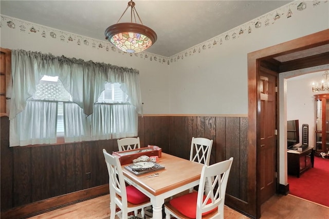 dining room with wooden walls