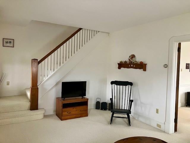 living area featuring carpet