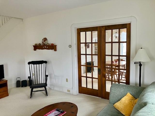 entryway featuring french doors and carpet