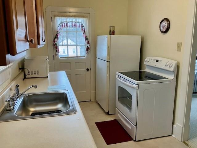 kitchen with white appliances and sink