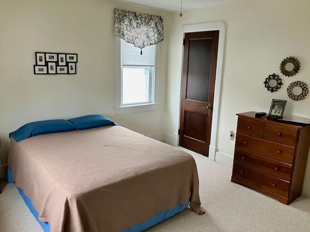 bedroom with light colored carpet