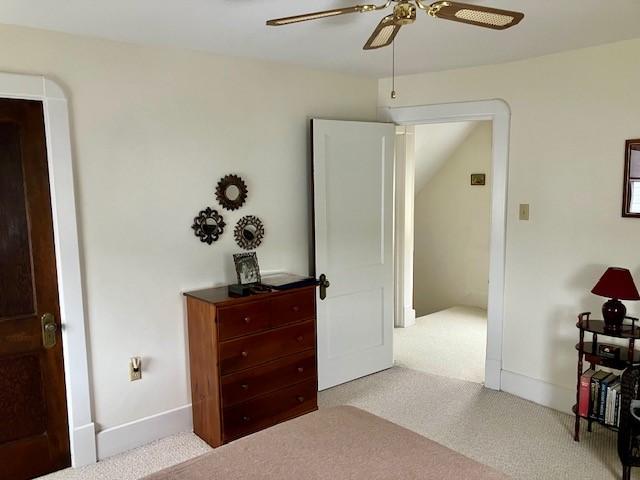 carpeted bedroom with ceiling fan