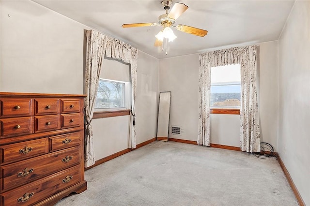 bedroom with ceiling fan and light carpet