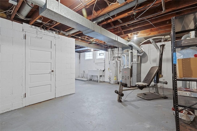 basement with water heater, sink, and heating unit