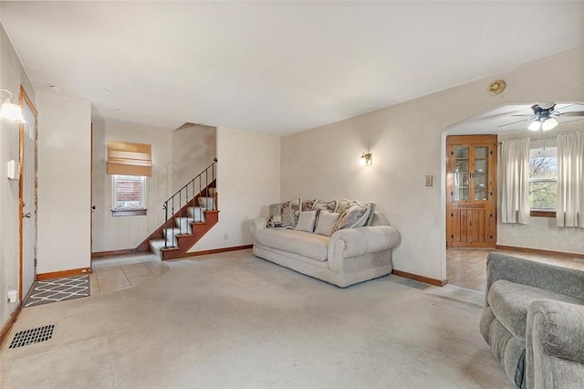 living room featuring light carpet and ceiling fan