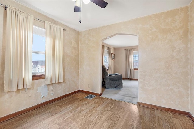 empty room featuring wood-type flooring and ceiling fan