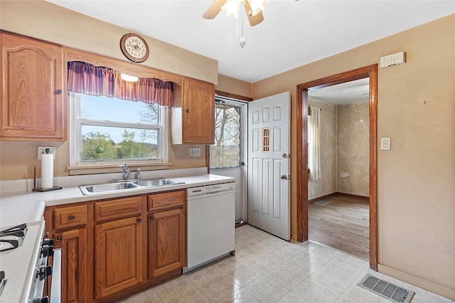 kitchen featuring ceiling fan, dishwasher, sink, and stainless steel gas range oven