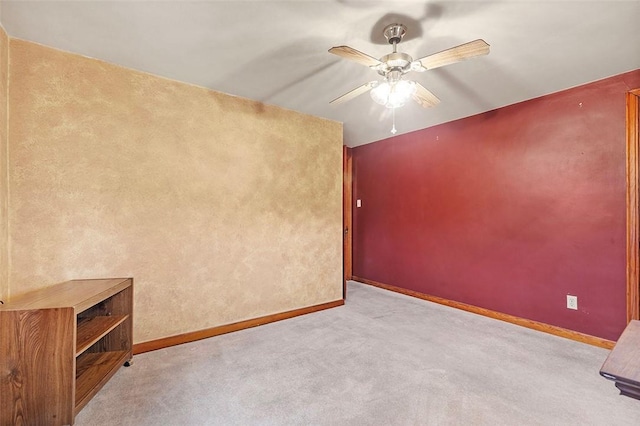 unfurnished room with light colored carpet and ceiling fan