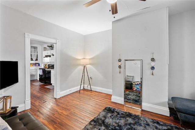 living room with hardwood / wood-style flooring and ceiling fan