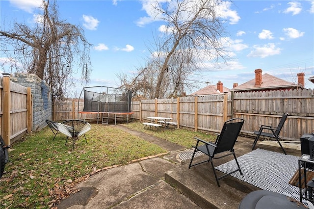 view of yard with a patio and a trampoline