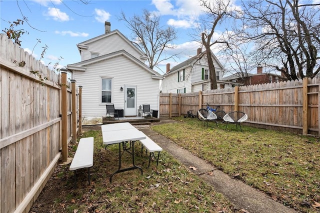 back of house featuring a lawn