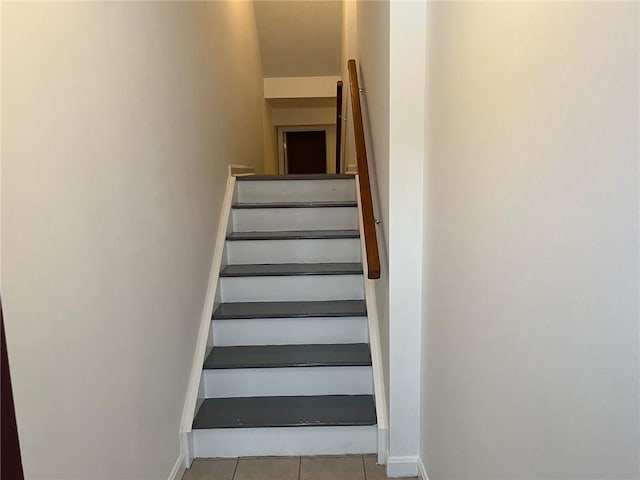 stairway featuring tile patterned floors