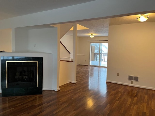 unfurnished living room with dark hardwood / wood-style flooring