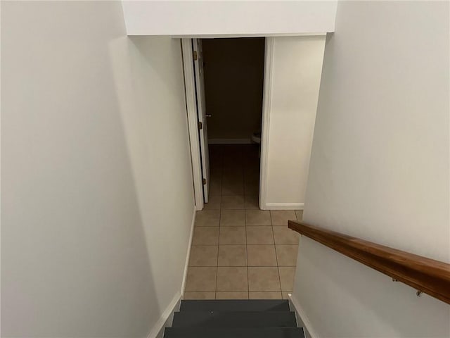 stairway with tile patterned floors