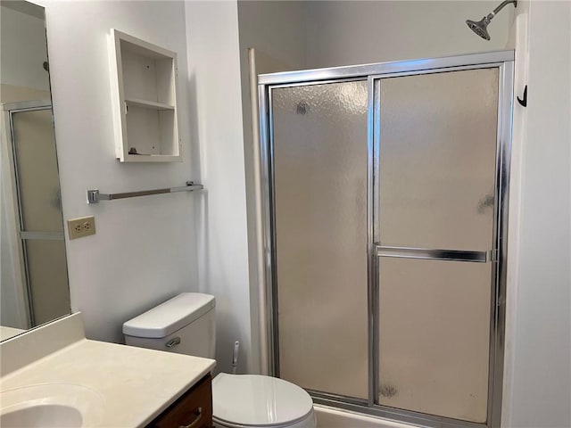 bathroom with vanity, an enclosed shower, and toilet