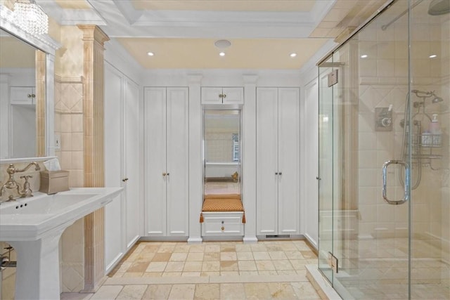 bathroom featuring ornate columns, crown molding, sink, and an enclosed shower