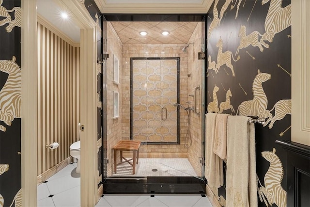 bathroom featuring crown molding, tile patterned floors, and toilet