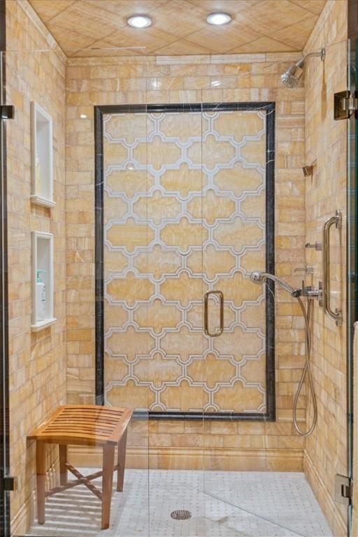 interior details with a tile shower