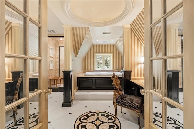 bathroom featuring a tub to relax in, tile patterned floors, and french doors